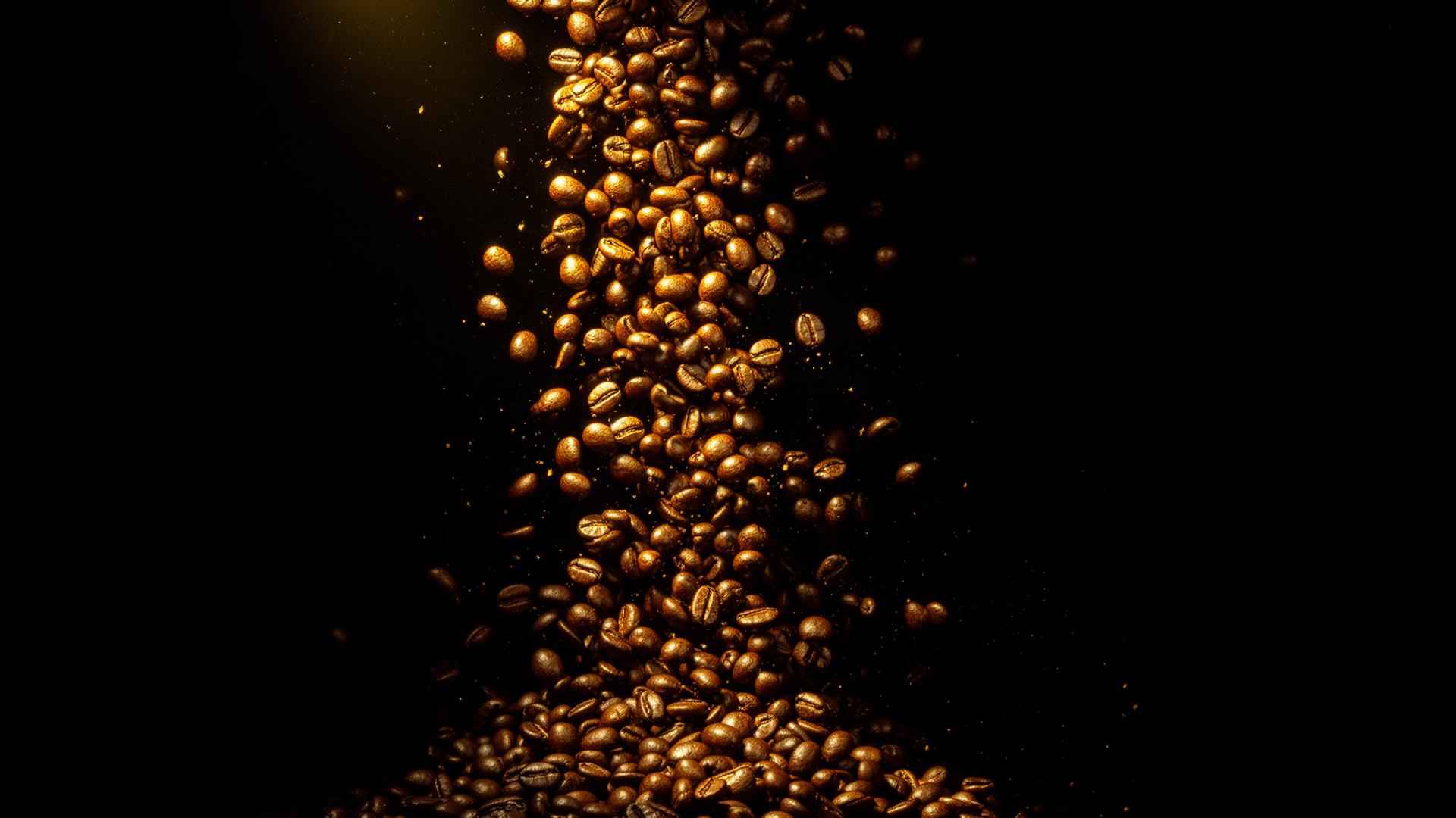 Roasted coffee beans cascading in golden light